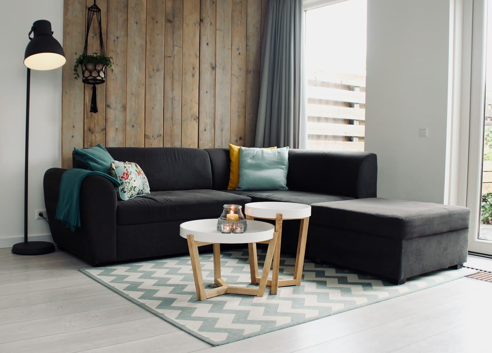 A sectional couch with cushions and a coffee table in a living room