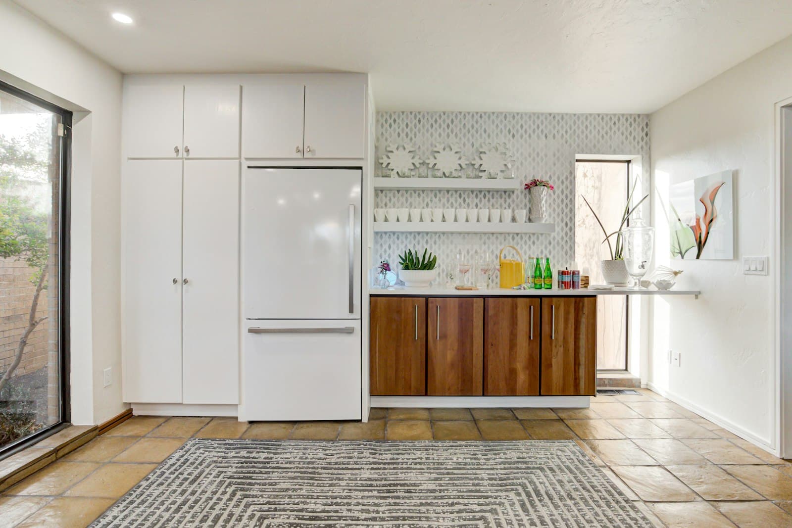A white refrigerator built into a kitchen with wooden cabinets