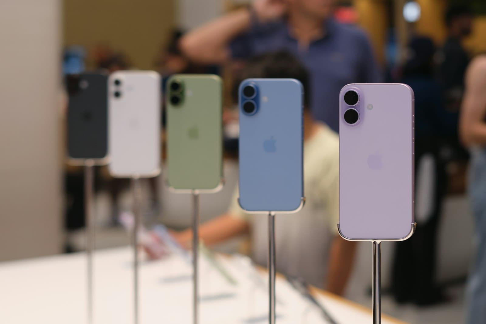 Smartphones in several colors on display stands in a store