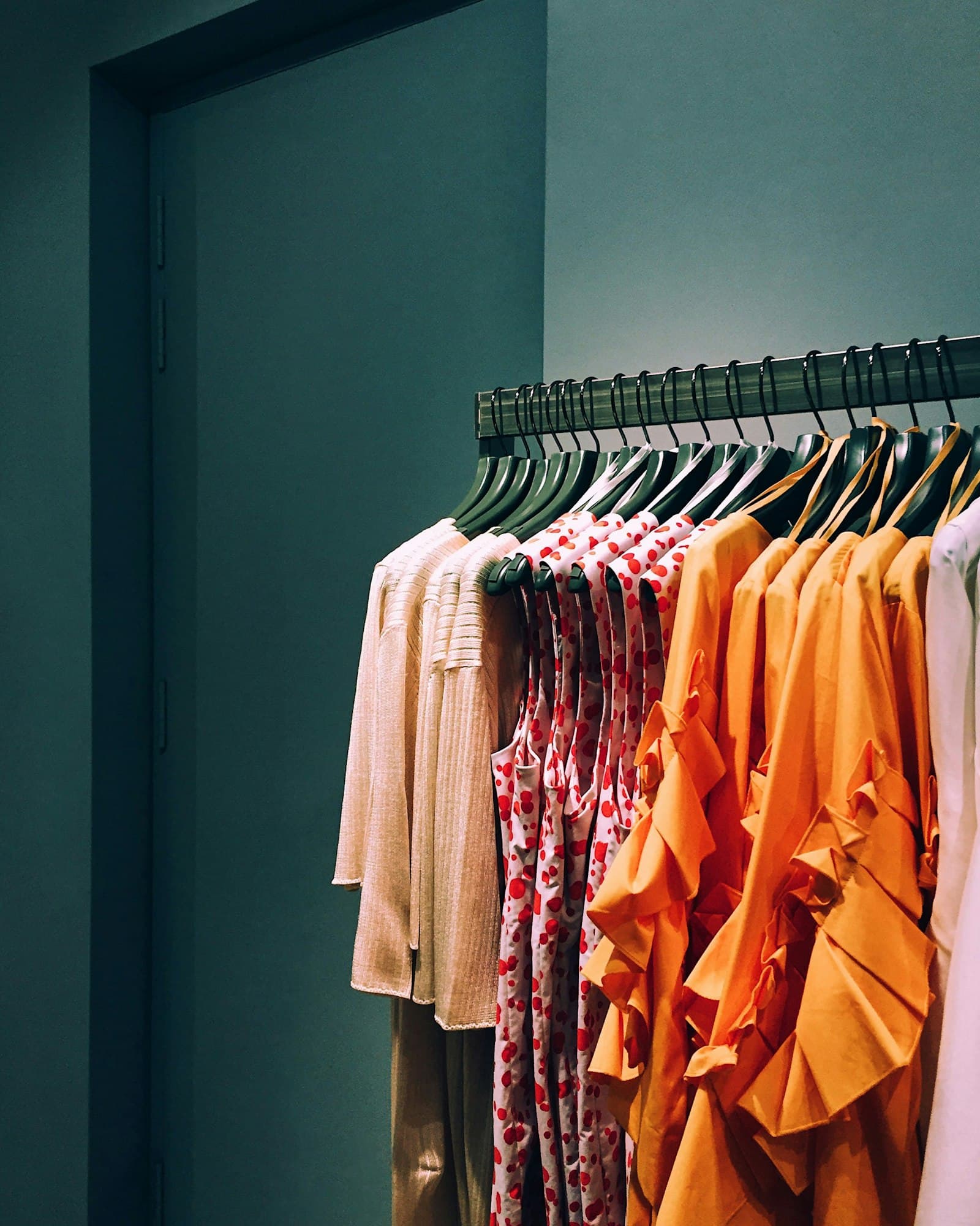 Colorful clothing hanging on a rack in a boutique
