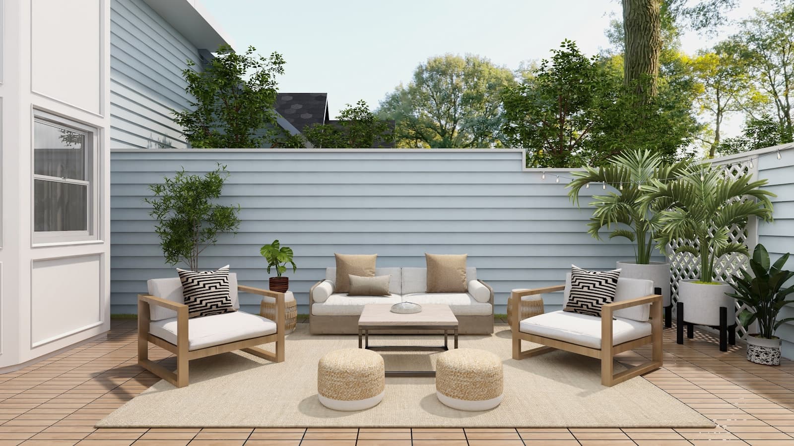 An outdoor sofa and armchairs on a wooden patio deck